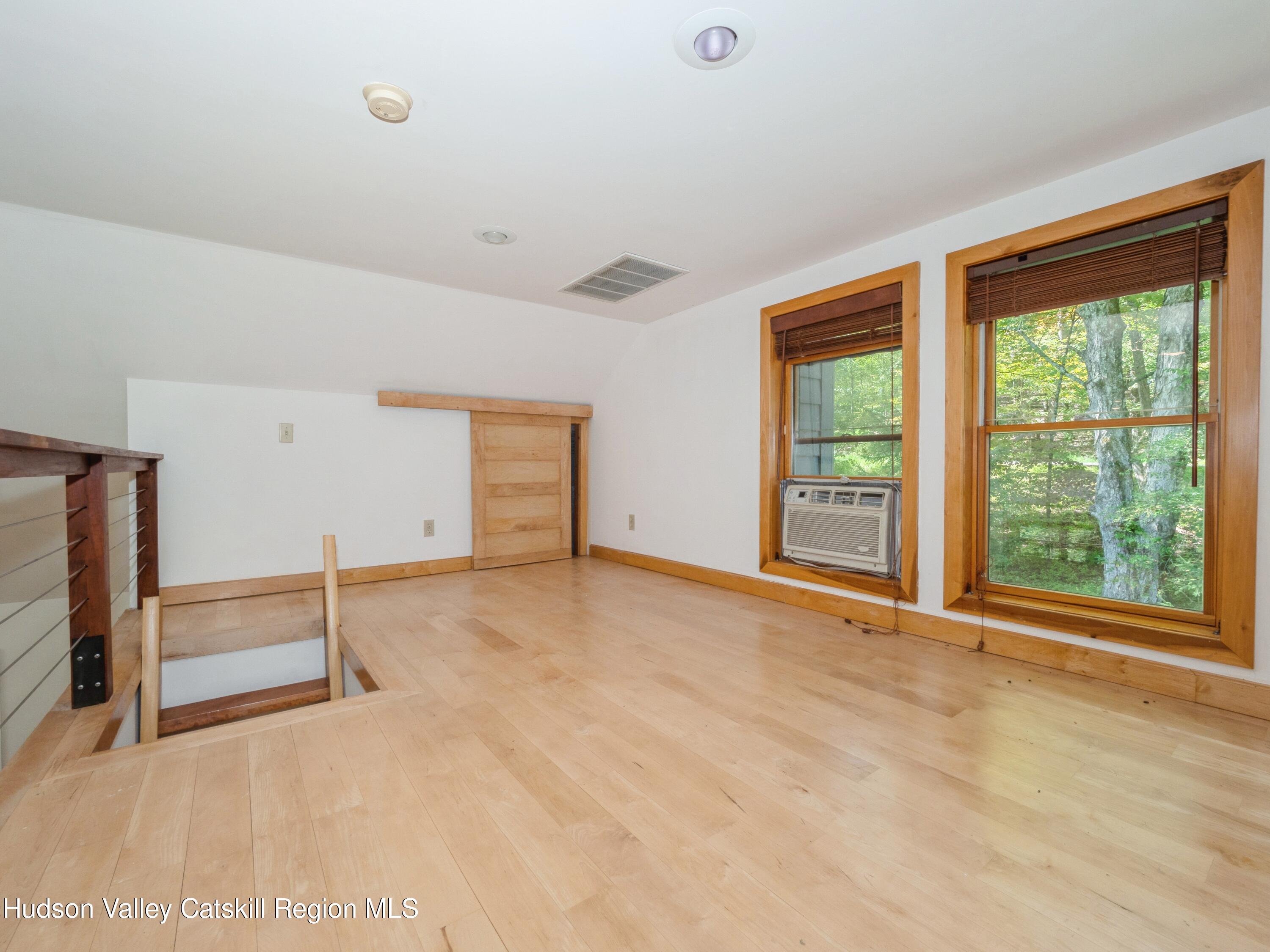 7 Clovewood Road High Falls, NY 12440 - Photo 19 of 41 an empty room with windows and pillars in it