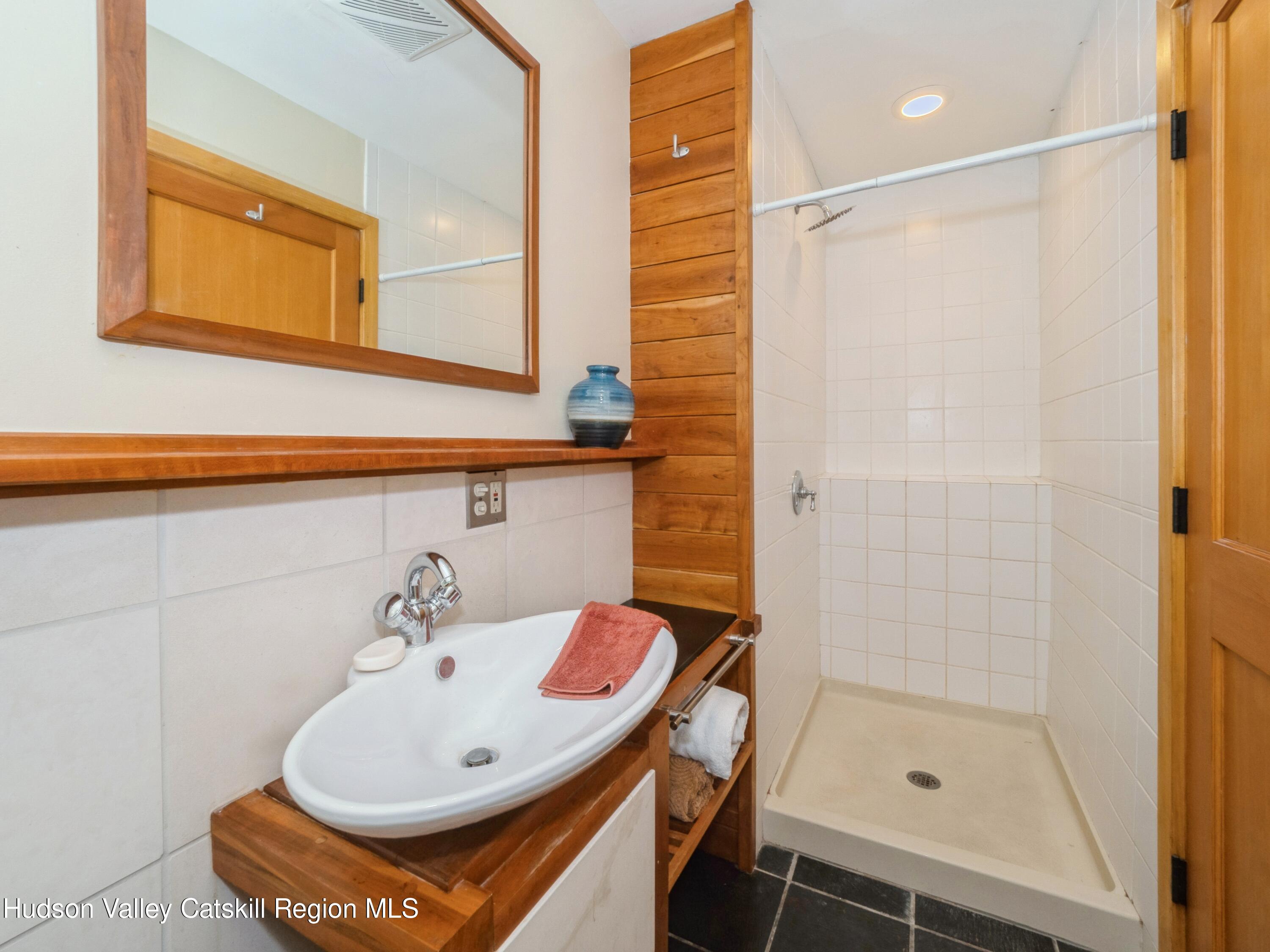 7 Clovewood Road High Falls, NY 12440 - Photo 28 of 41 a bathroom with a sink a mirror and a shower