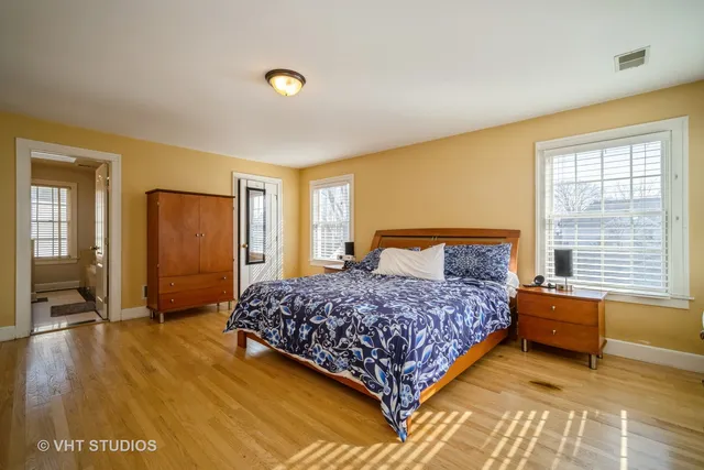 a bedroom with a bed dresser and a window