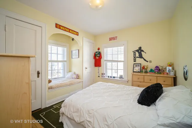 a bedroom with a bed mirror and a window