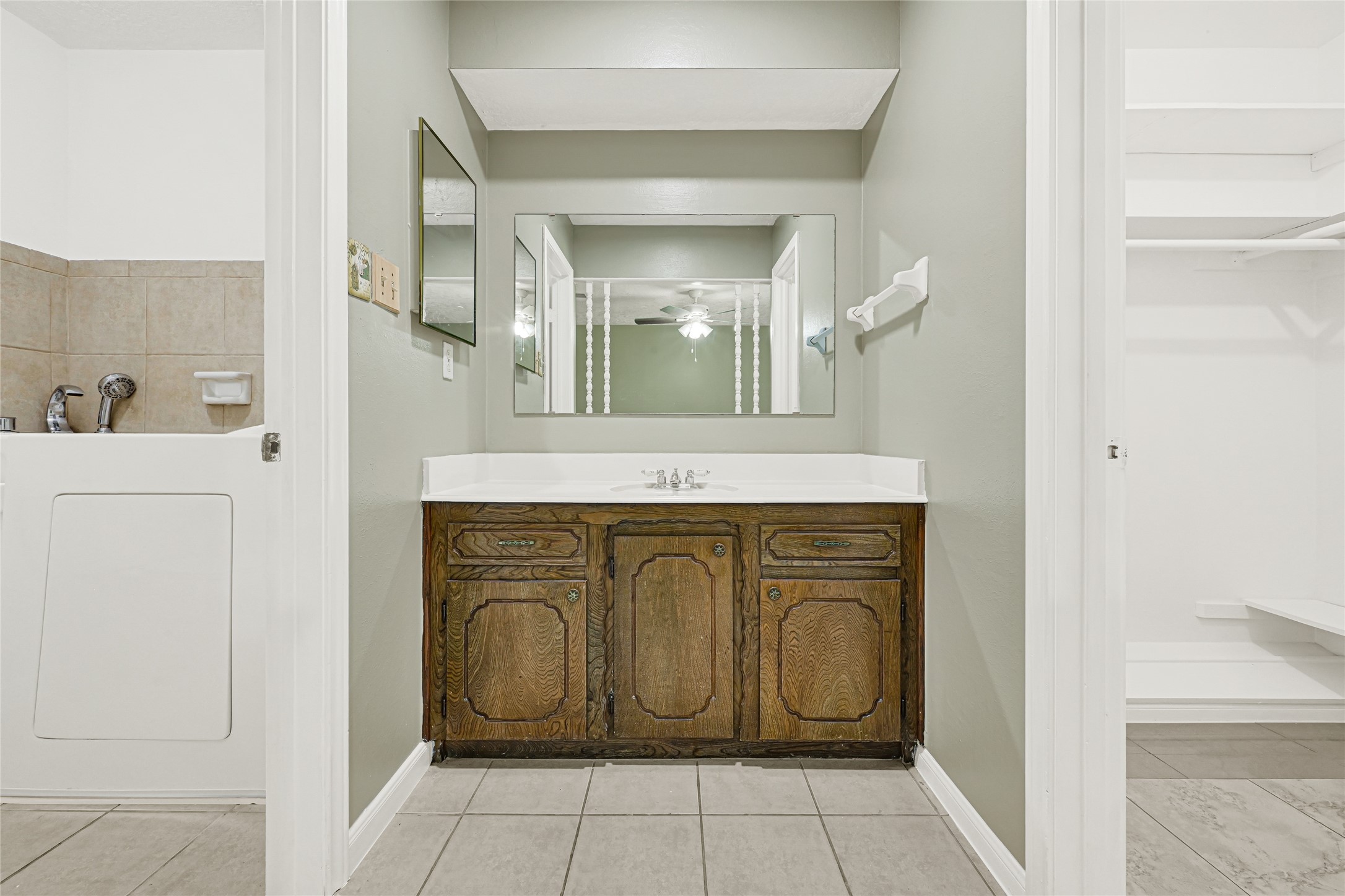 20135 Timber Line Lane New Caney, TX 77357 - Photo 21 of 30 a bathroom with a granite countertop sink and a mirror