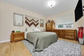 a bedroom with a large bed and dresser
