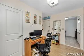 a view of a workspace with furniture and a window
