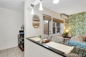 a view of a hallway to a livingroom with furniture