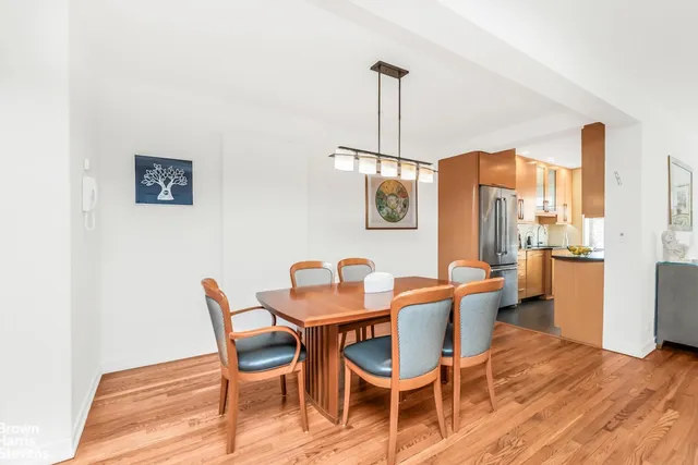 a dining room with furniture and wooden floor