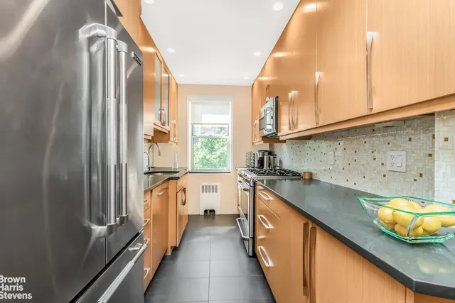 a kitchen with a sink a stove and cabinets