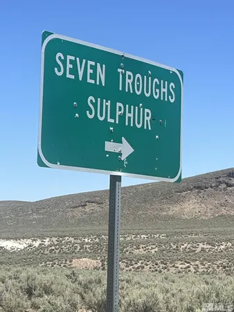 a sign board on the side of a road