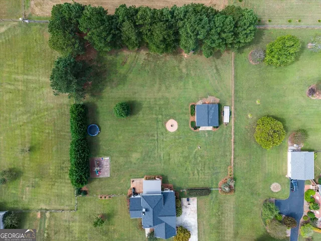 a view of a garden with a building in the background
