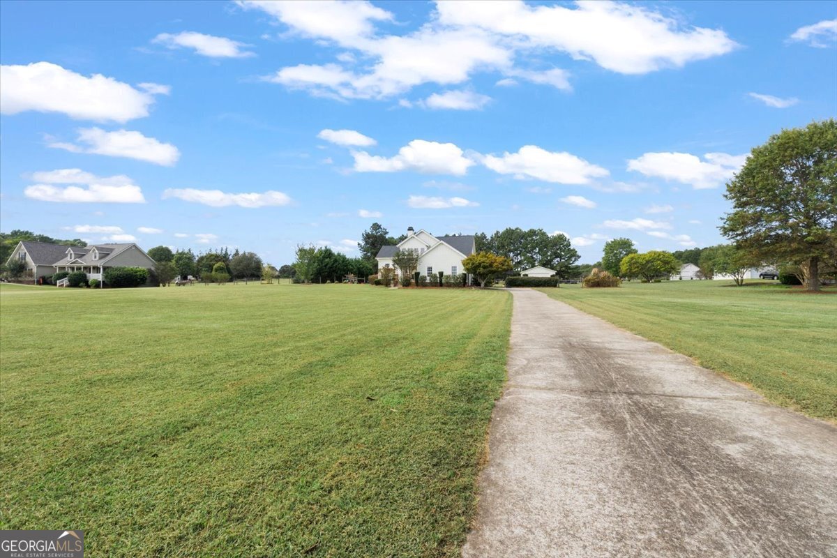1670 Price Mill Road Bishop, GA 30621 - Photo 16 of 53 a view of a garden with a building in the background