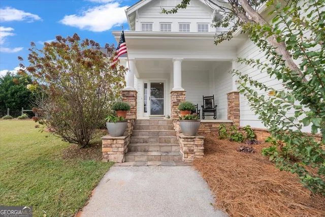 a front view of a house with a yard and fountain