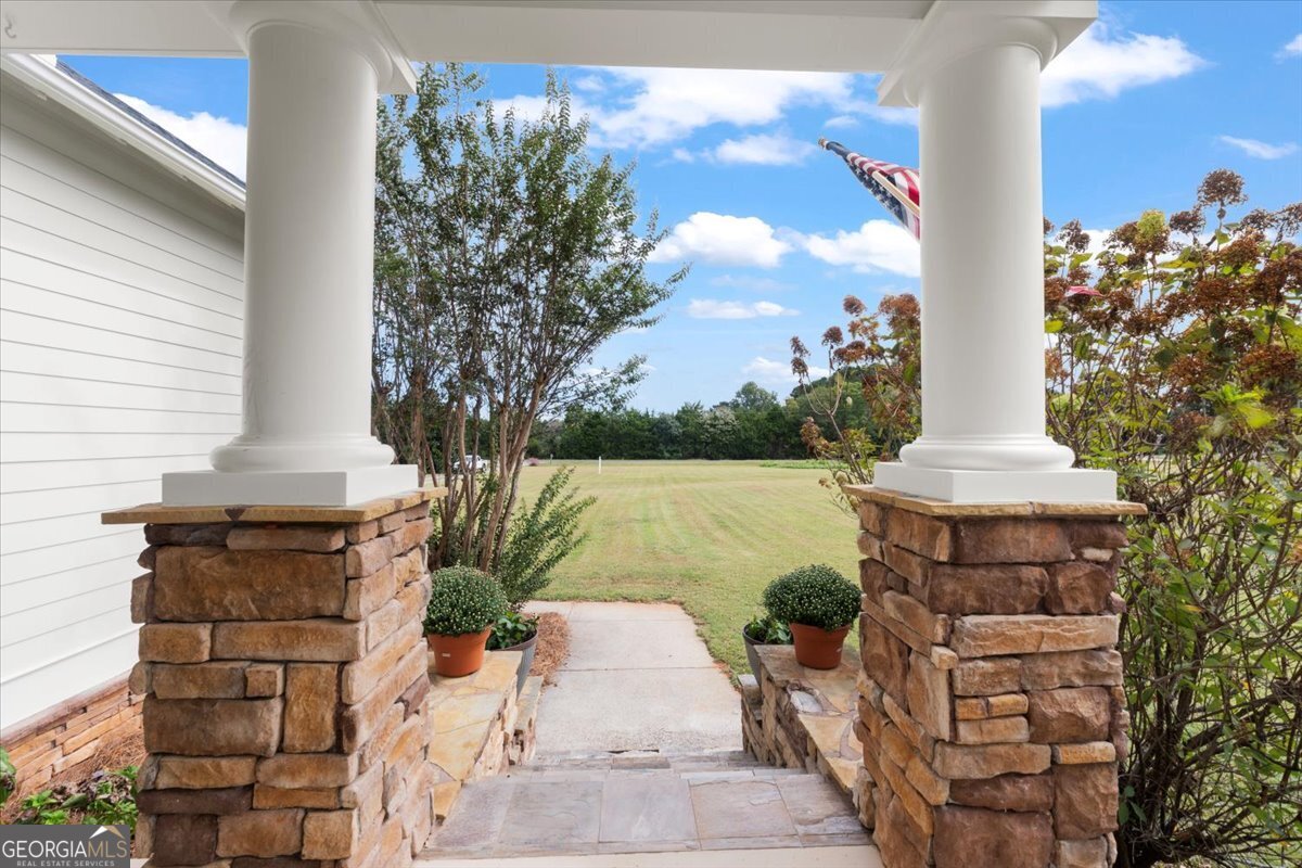 1670 Price Mill Road Bishop, GA 30621 - Photo 18 of 53 a front view of a house with a yard and fountain