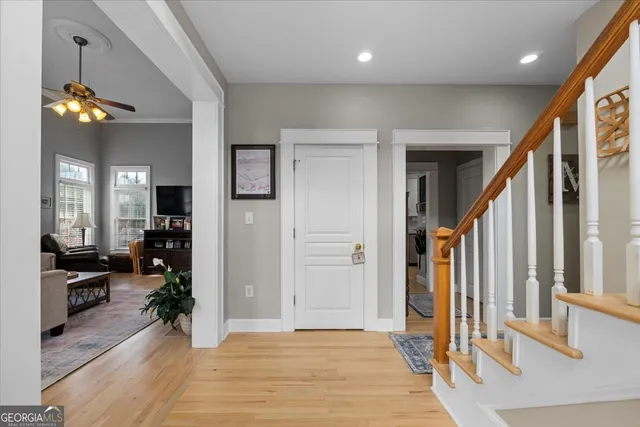 a living room with furniture ceiling fan and a window