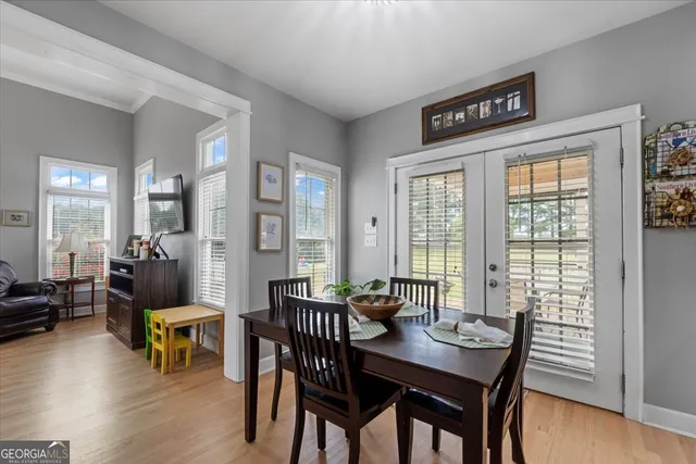 a view of a dining room with furniture window and wooden floor