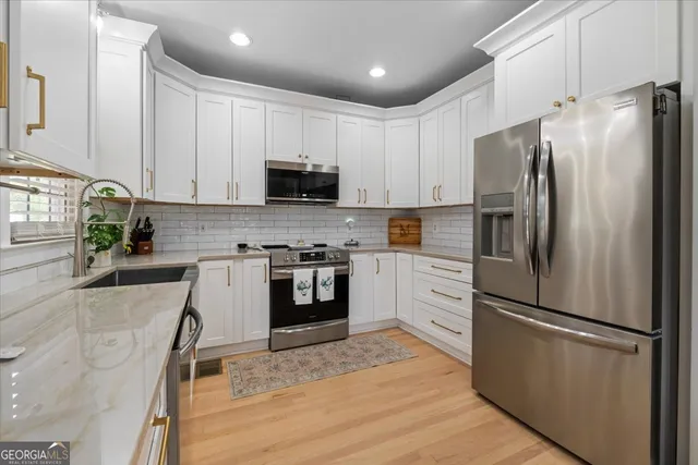 a kitchen with granite countertop a stove and a sink