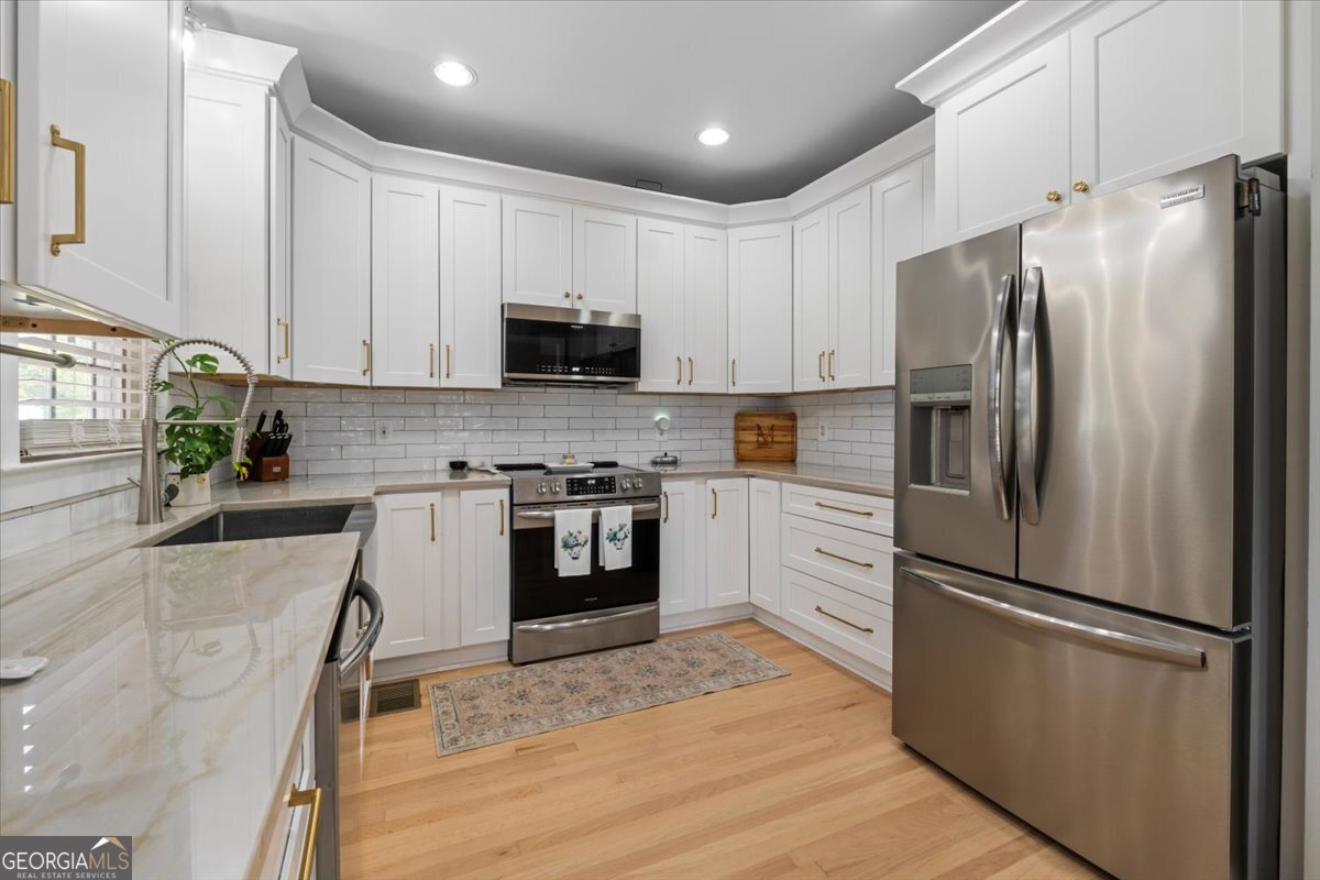 1670 Price Mill Road Bishop, GA 30621 - Photo 27 of 53 a kitchen with stainless steel appliances a refrigerator sink and microwave