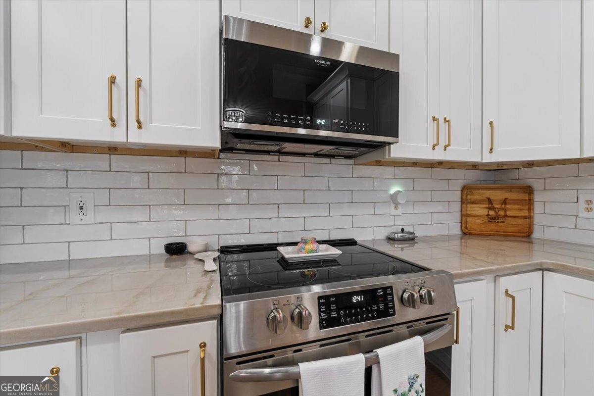 1670 Price Mill Road Bishop, GA 30621 - Photo 28 of 53 a kitchen with granite countertop a stove and a sink
