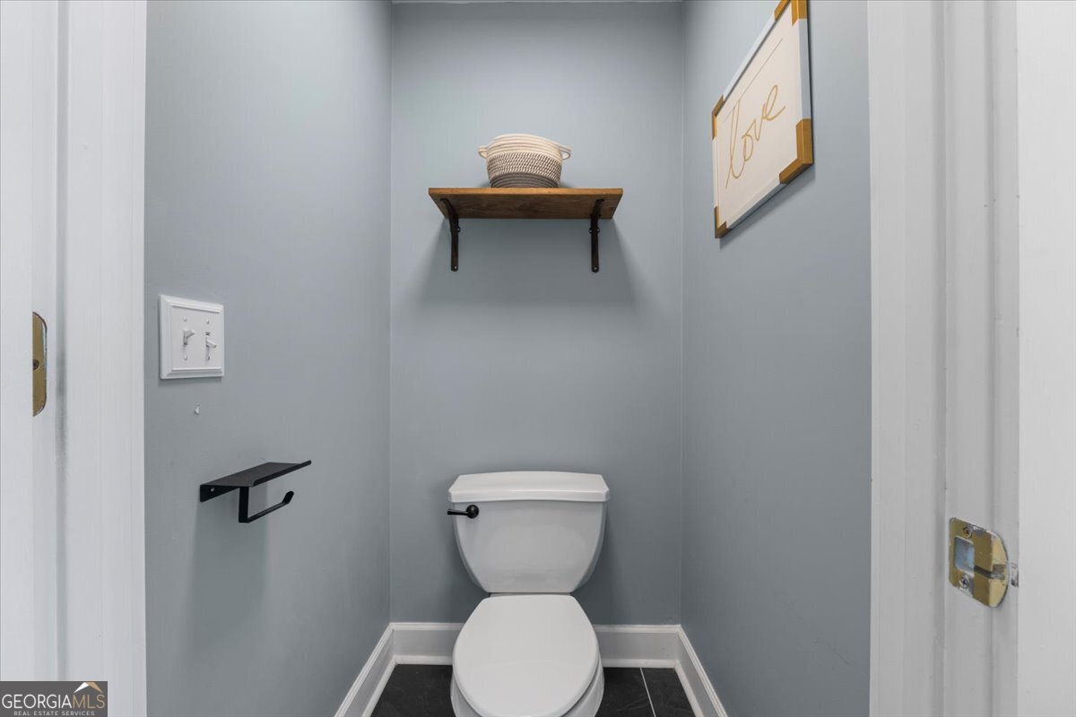 1670 Price Mill Road Bishop, GA 30621 - Photo 37 of 53 a bathroom with a toilet sink and mirror