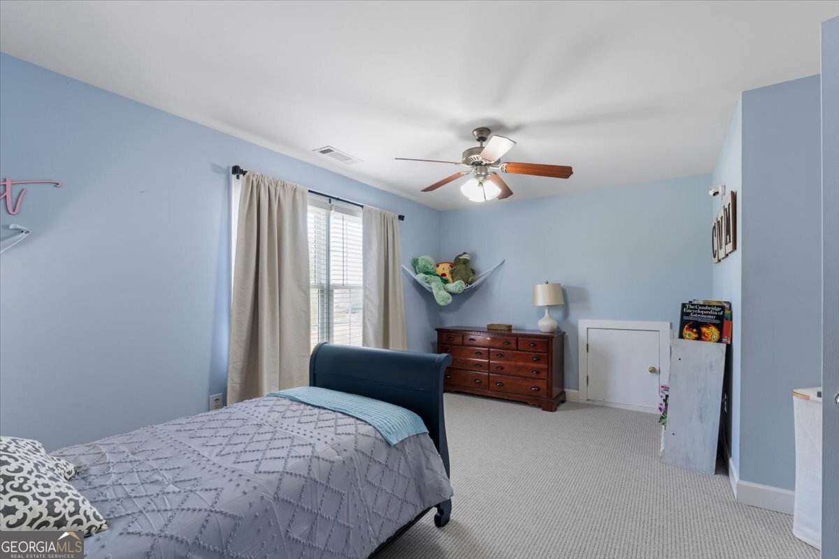 1670 Price Mill Road Bishop, GA 30621 - Photo 45 of 53 a bedroom with a bed and ceiling fan