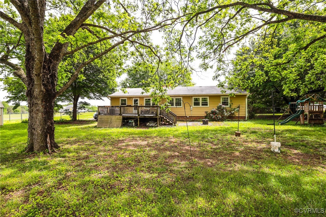8229 Little Florida Road Mechanicsville, VA 23111 - Photo 16 of 40 Back of property with a yard, a wooden deck, a pla