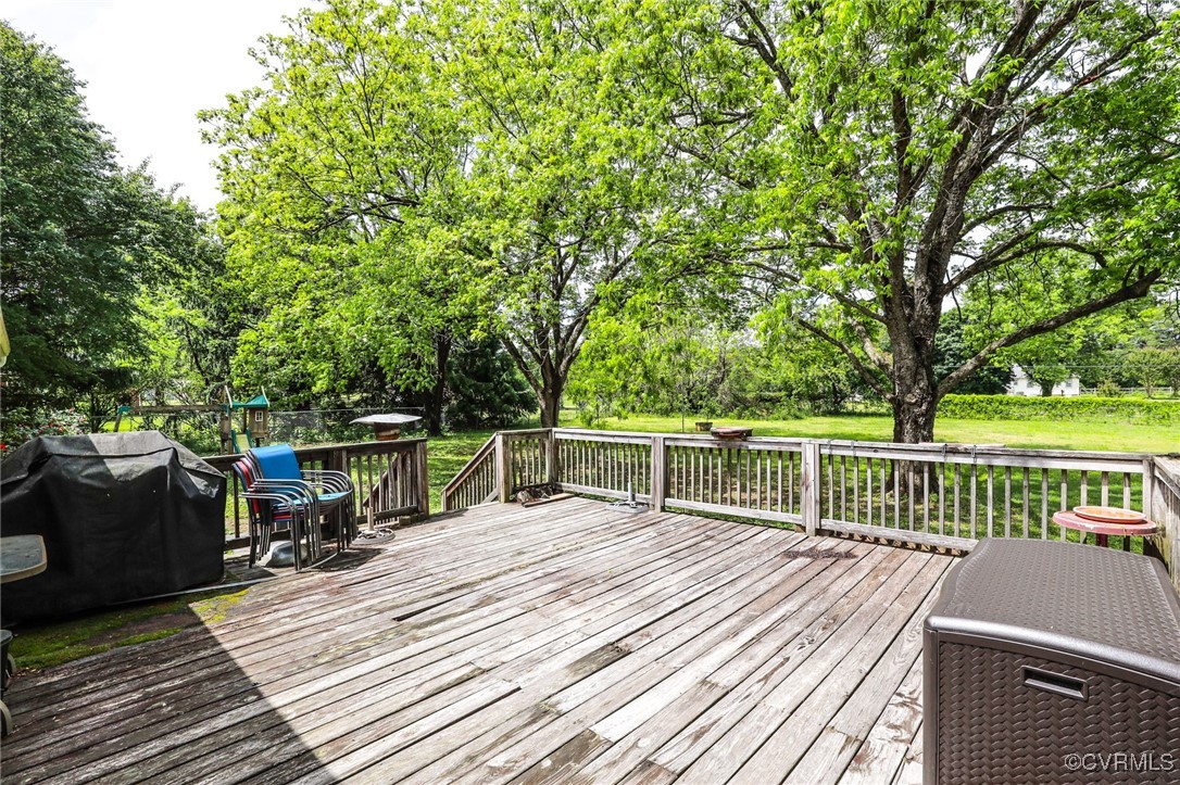 8229 Little Florida Road Mechanicsville, VA 23111 - Photo 21 of 40 Wooden terrace with a grill and a lawn