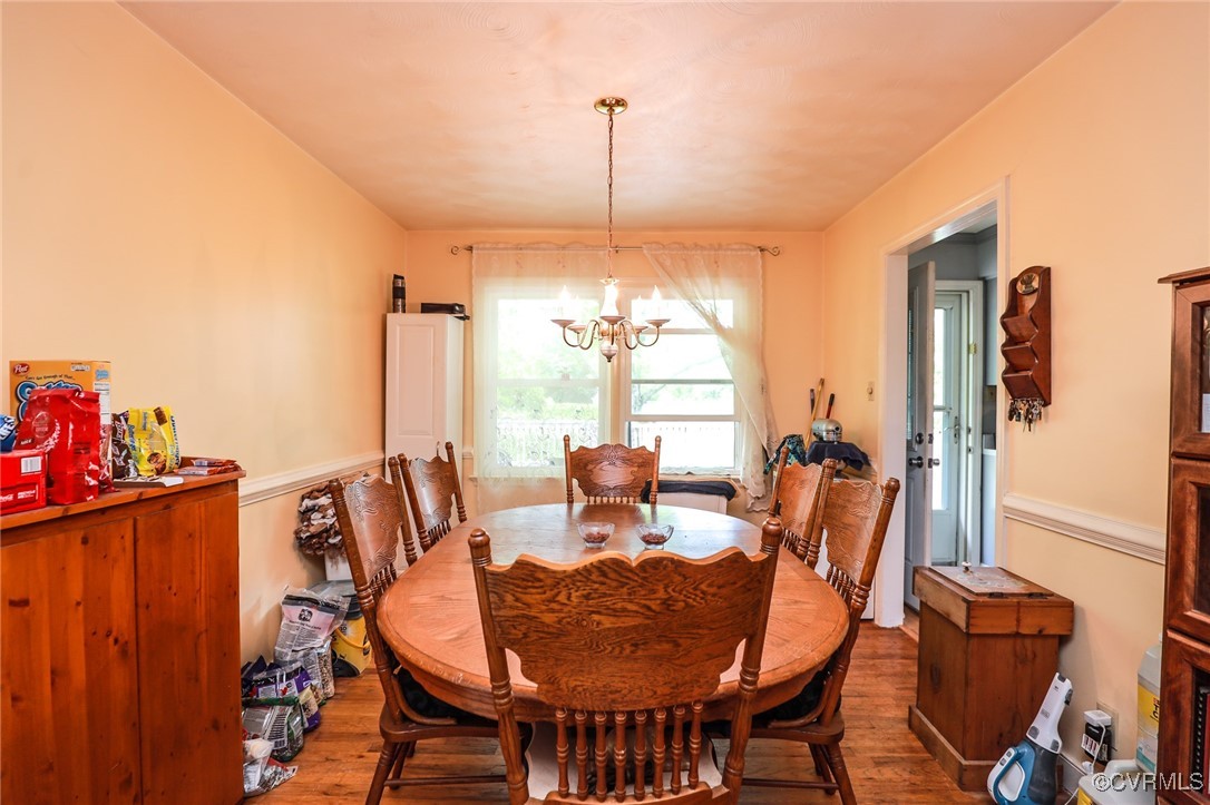 8229 Little Florida Road Mechanicsville, VA 23111 - Photo 27 of 40 Dining space featuring a chandelier and wood finis