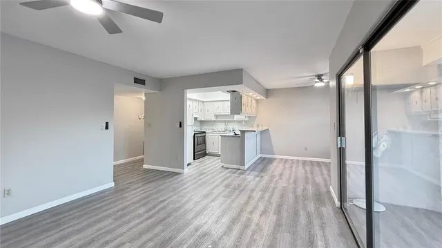 a view of a kitchen with wooden floor and a kitchen
