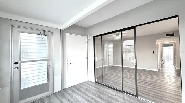 a view of an entryway with wooden floor