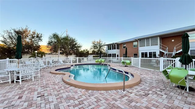 a view of a house with swimming pool and sitting area