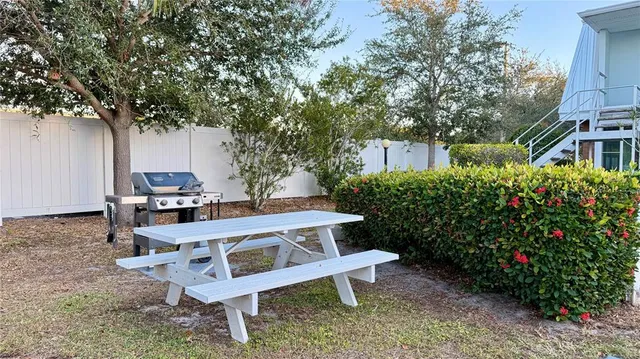 a view of a yard with a house and outdoor seating