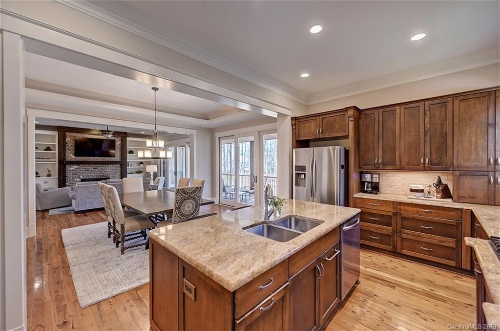 146 Dedham Loop Mooresville, NC 28117 - Photo 11 of 29 a kitchen with stainless steel appliances granite countertop a sink refrigerator and cabinets