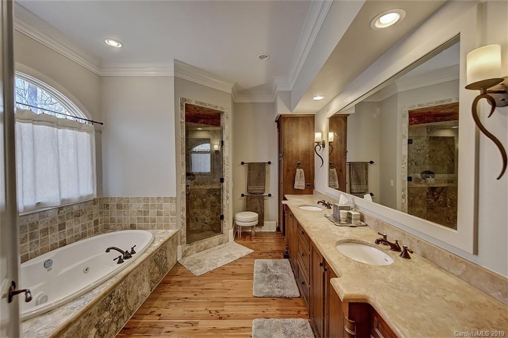 146 Dedham Loop Mooresville, NC 28117 - Photo 17 of 29 a bathroom with a granite countertop tub sink shower and mirror