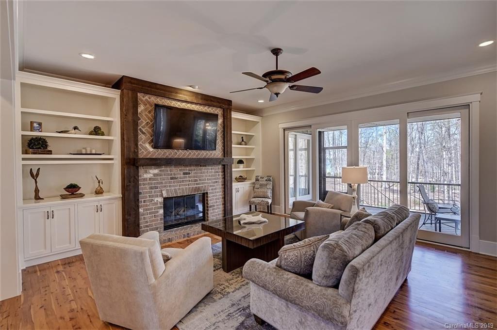 146 Dedham Loop Mooresville, NC 28117 - Photo 3 of 29 a living room with furniture a flat screen tv and a fireplace