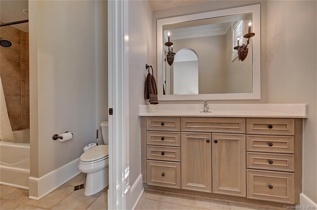 146 Dedham Loop Mooresville, NC 28117 - Photo 21 of 29 a bathroom with a toilet a sink a vanity and mirror