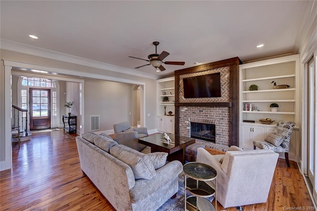 146 Dedham Loop Mooresville, NC 28117 - Photo 4 of 29 a living room with furniture a fireplace and a flat screen tv