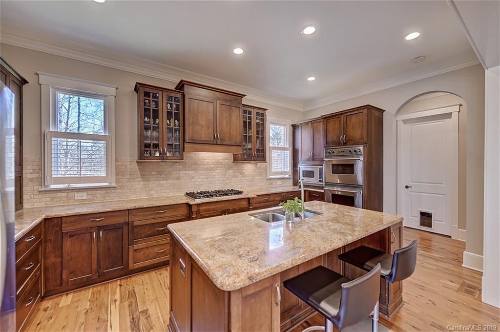 146 Dedham Loop Mooresville, NC 28117 - Photo 10 of 29 a kitchen with stainless steel appliances granite countertop a kitchen island hardwood floor sink stove and granite counter top