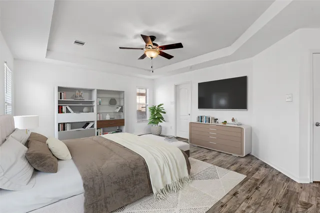 a bedroom with a bed and a flat screen tv