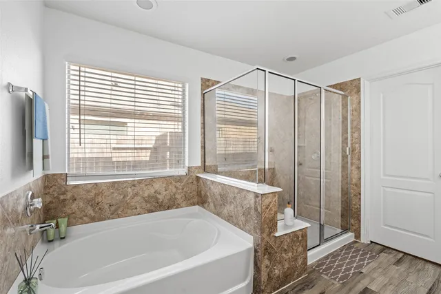 a bathroom with a bathtub and a shower