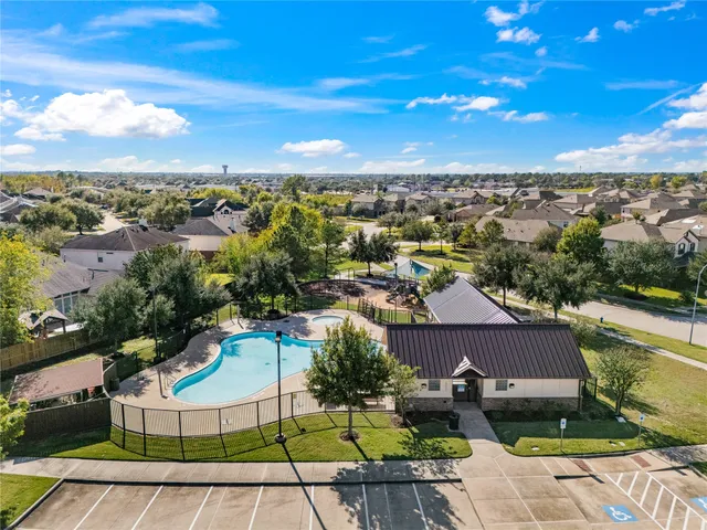 an aerial view of a house with a swimming pool