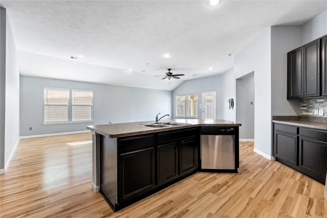 a kitchen with granite countertop a stove and cabinets