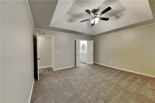 an empty room with closet and ceiling fan