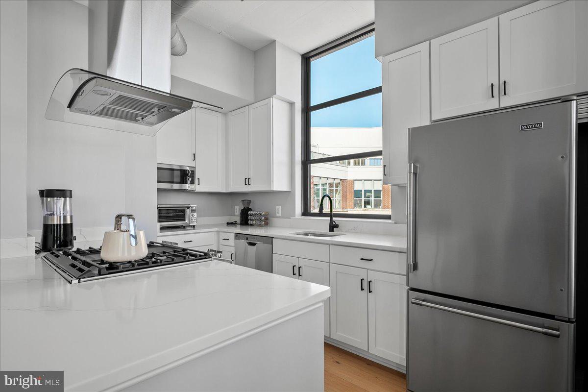 2020 12th Street Northwest, Unit 812 Washington, DC 20009 - Photo 11 of 38 a kitchen with white cabinets and white appliances