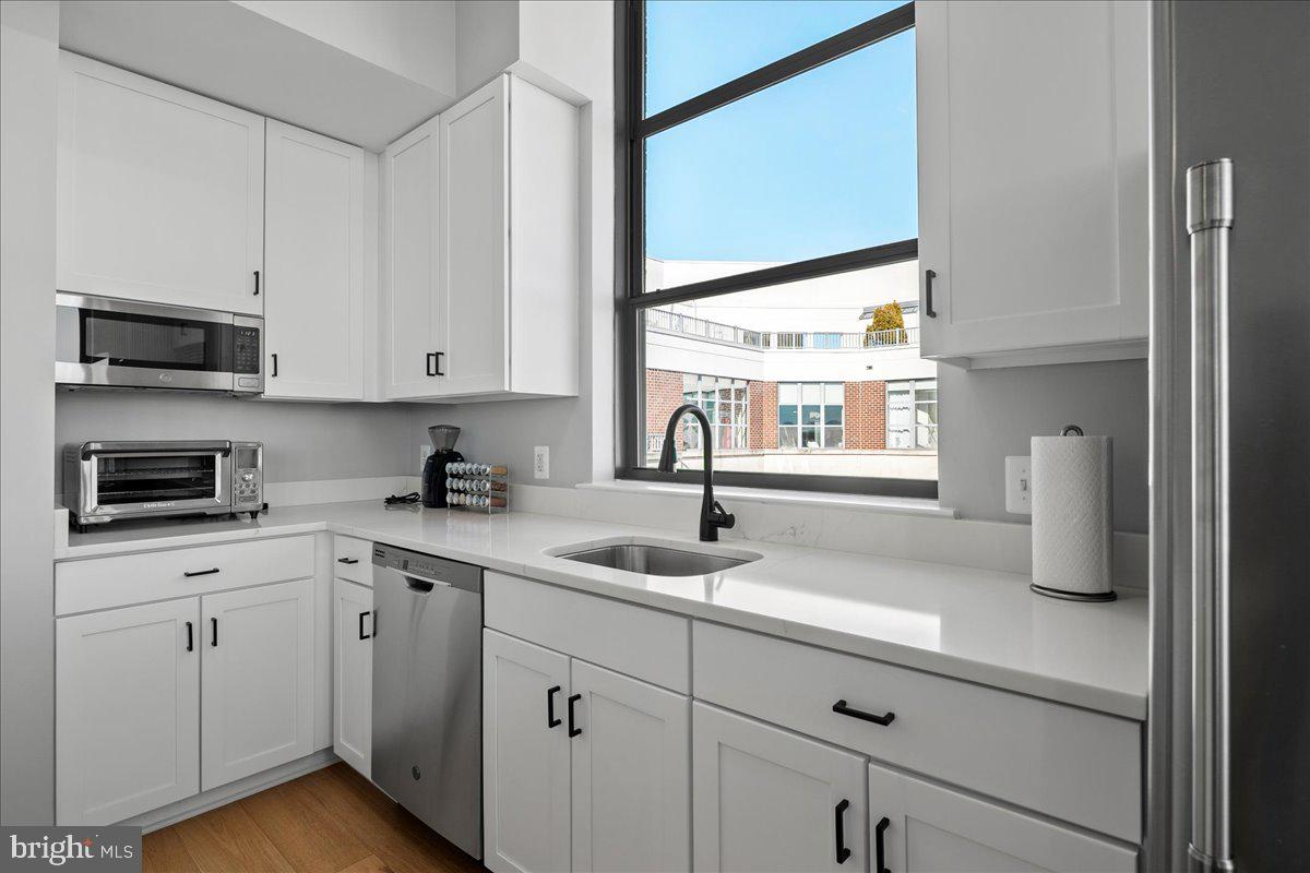 2020 12th Street Northwest, Unit 812 Washington, DC 20009 - Photo 13 of 38 a kitchen with a sink cabinets and window