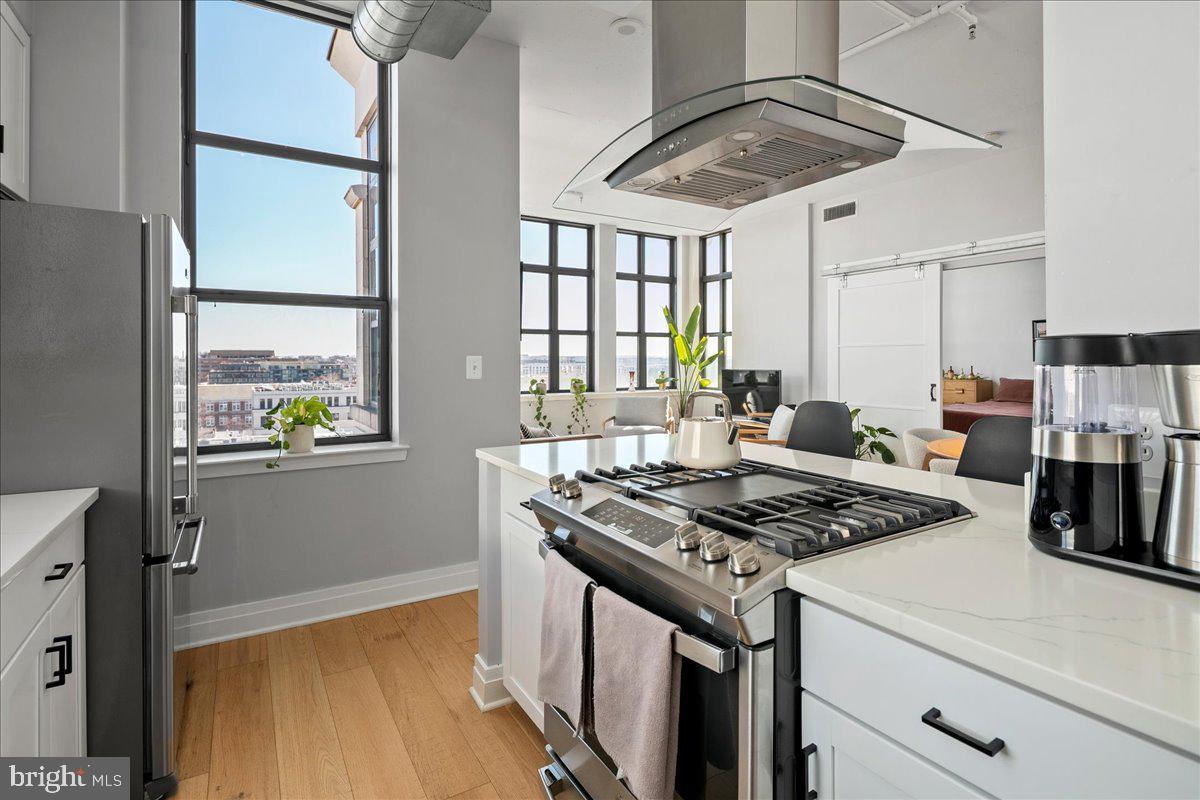 2020 12th Street Northwest, Unit 812 Washington, DC 20009 - Photo 14 of 38 a kitchen that has a stove and a table in it