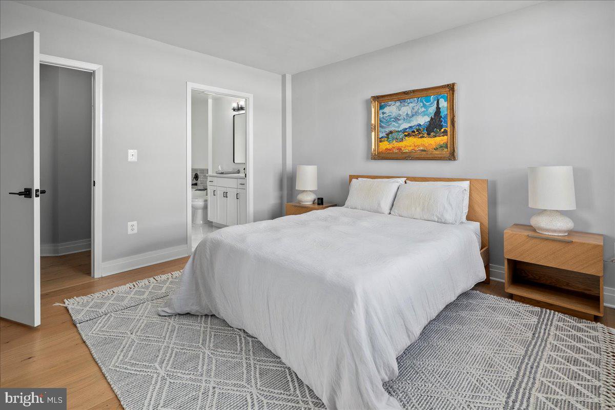 2020 12th Street Northwest, Unit 812 Washington, DC 20009 - Photo 16 of 38 a bedroom with a bed and a painting on the wall