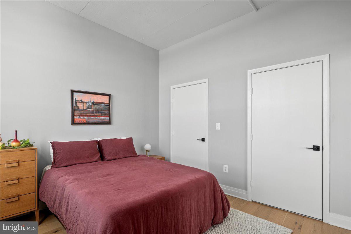 2020 12th Street Northwest, Unit 812 Washington, DC 20009 - Photo 21 of 38 a bedroom with a bed and a lamp on dresser