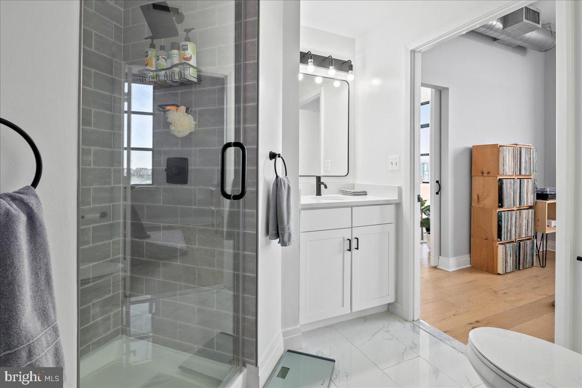 2020 12th Street Northwest, Unit 812 Washington, DC 20009 - Photo 22 of 38 a bathroom with a shower a mirror and a sink
