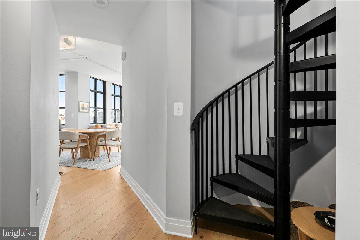 2020 12th Street Northwest, Unit 812 Washington, DC 20009 - Photo 24 of 38 a view of a hallway with wooden floor and windows