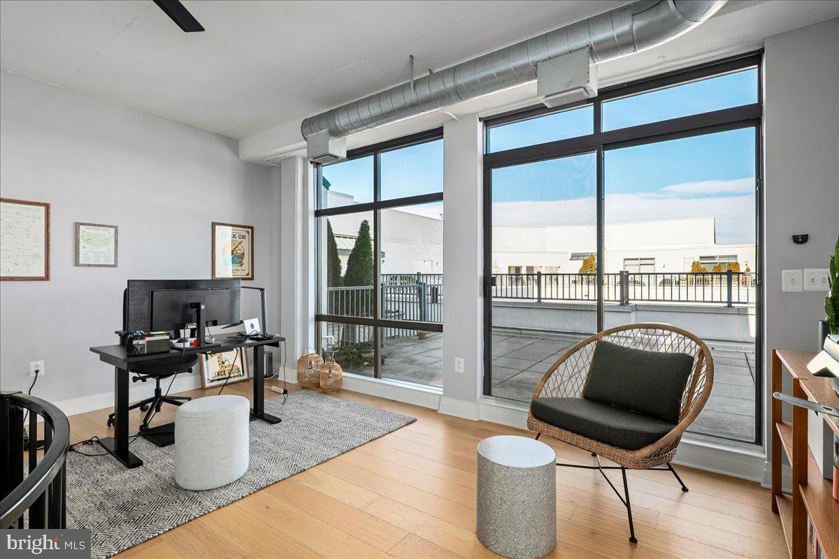 2020 12th Street Northwest, Unit 812 Washington, DC 20009 - Photo 27 of 38 a living room with furniture and a floor to ceiling window