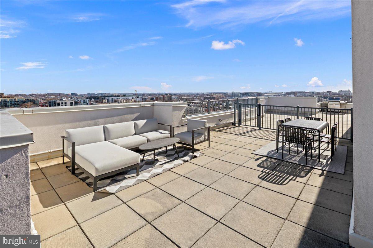 2020 12th Street Northwest, Unit 812 Washington, DC 20009 - Photo 28 of 38 a terrace with outdoor seating and city view