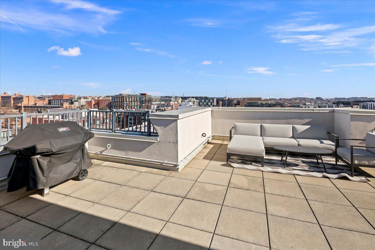 2020 12th Street Northwest, Unit 812 Washington, DC 20009 - Photo 30 of 38 a terrace with outdoor seating and city view